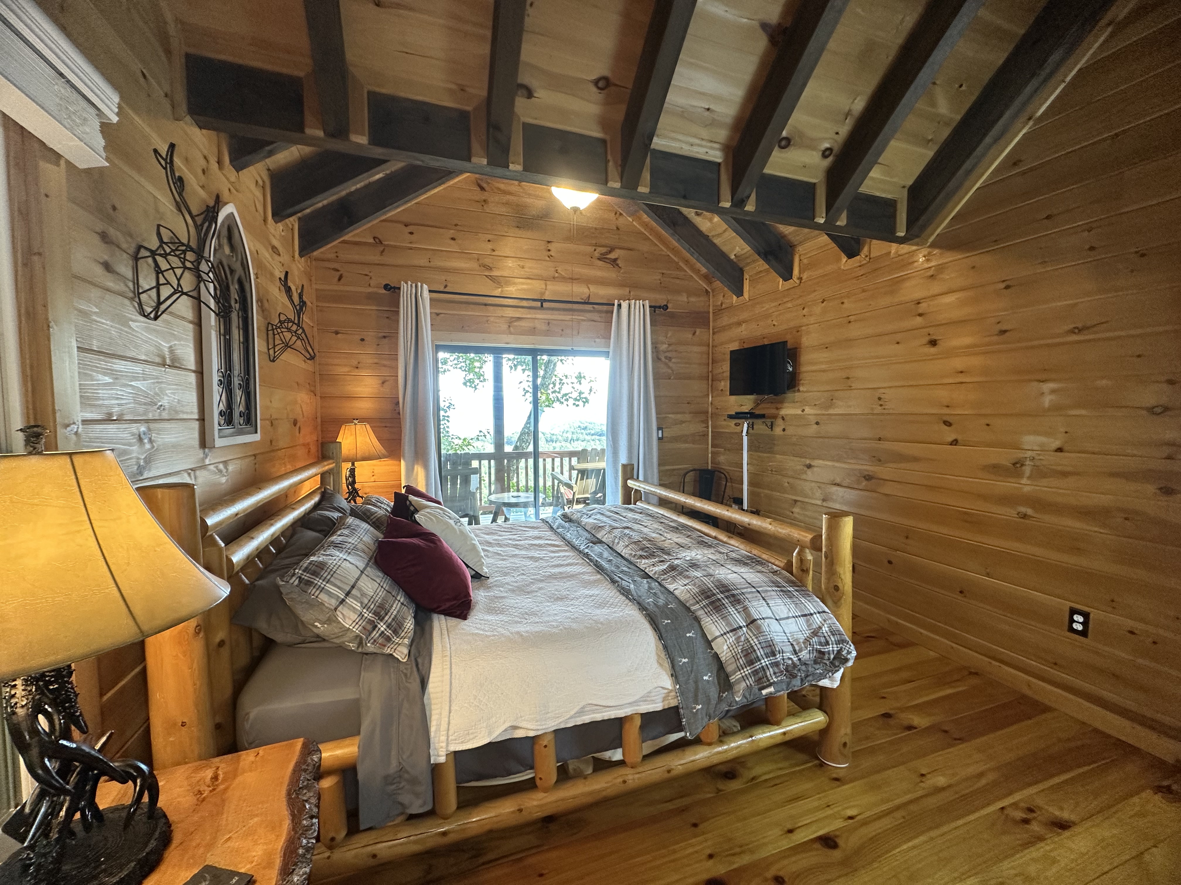 Upper level bedroom with warm wood tones and a quiet cabin feel.